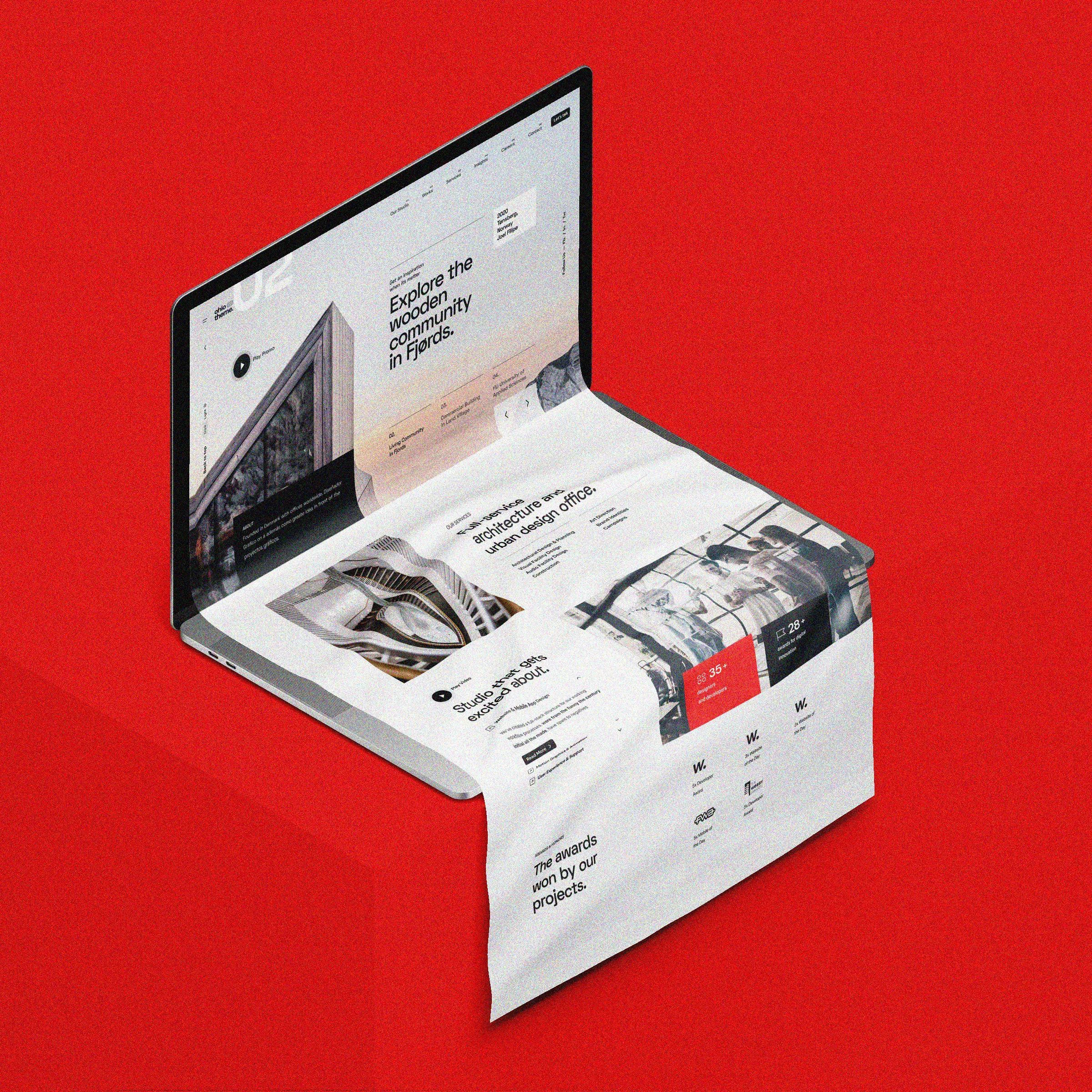 Laptop showing the Baum Architekten website on a red background