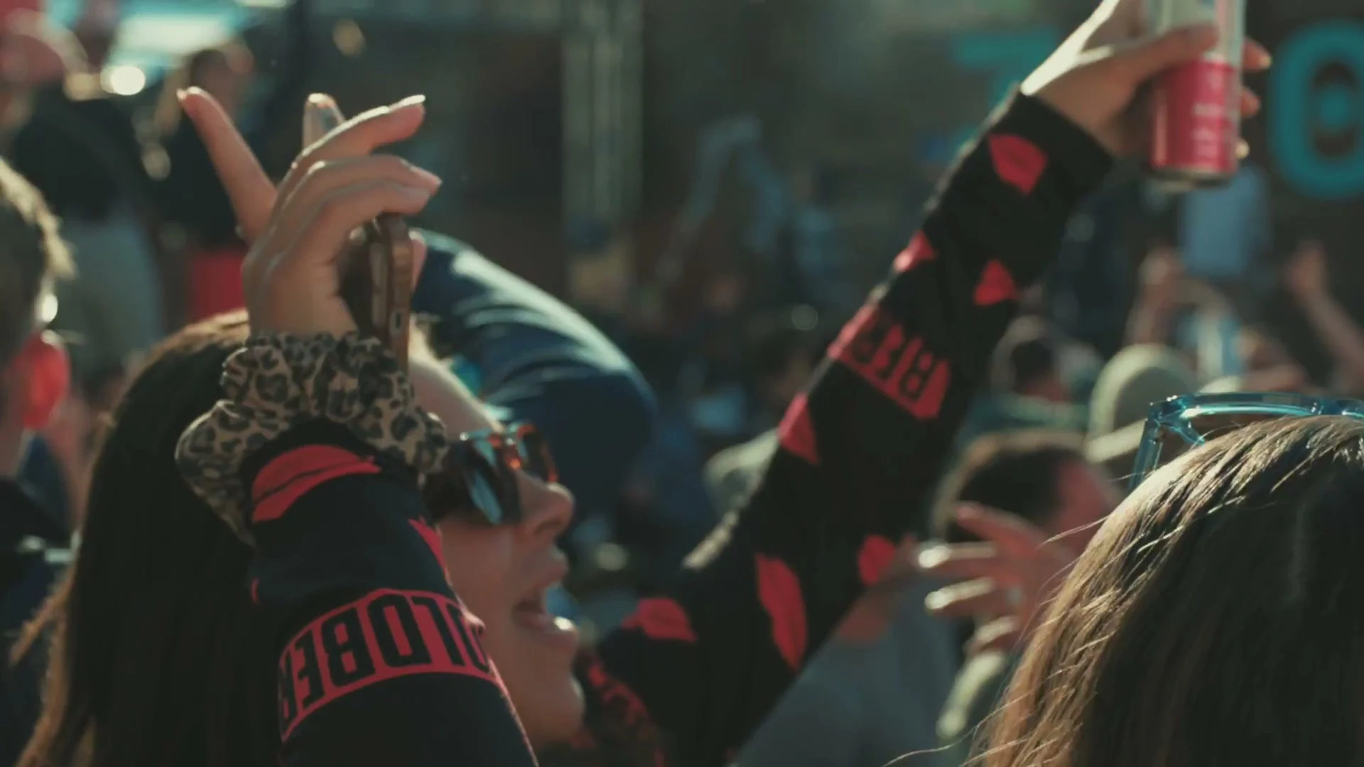 Festival-goer raising a can of Stëlz in the crowd