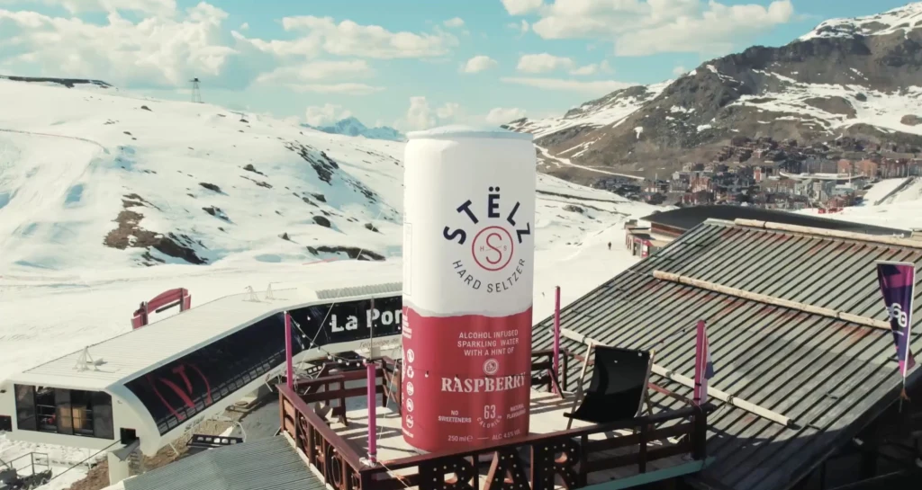 Giant inflatable drinks can on a terrace in the mountains