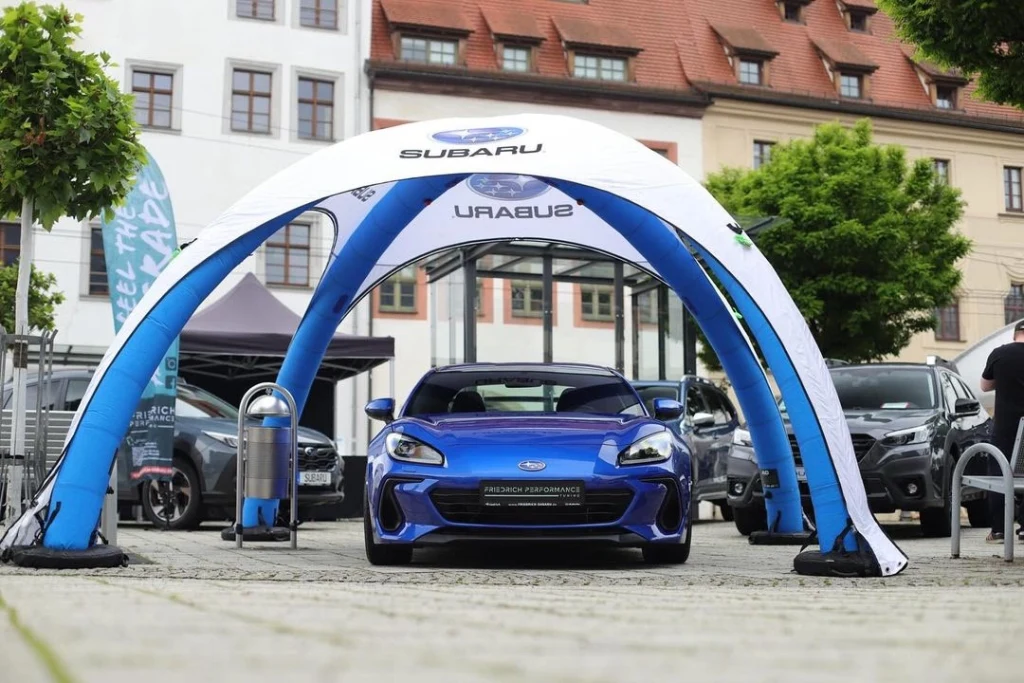 Blue and white branded Airdome over a sports car
